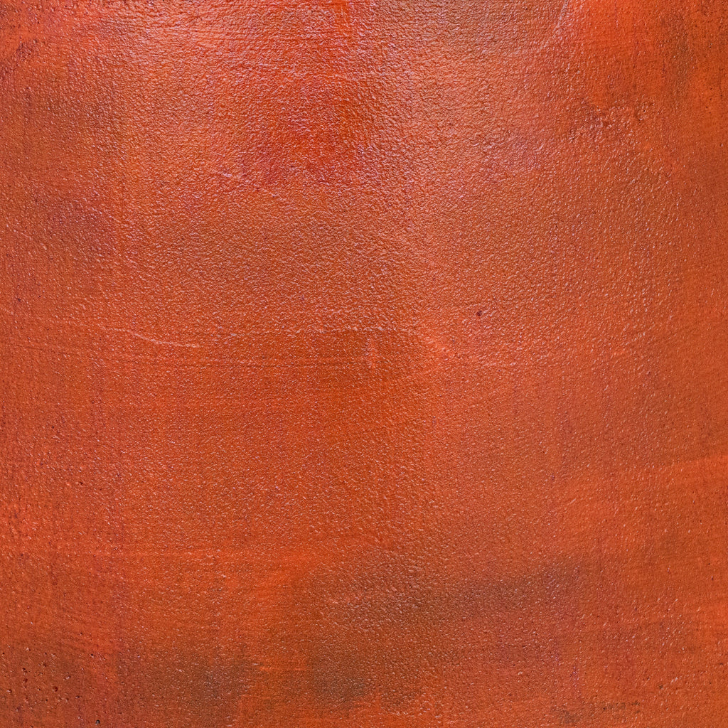 An abstract texture of Van Roosberg stool featuring a rich, warm rust-orange and terracotta color palette. Finished with highest quality micro-cement Mortex.