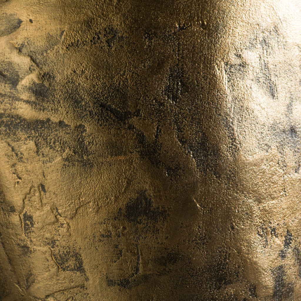 A handmade sculptural stool with a feminine curvy shape and finished with a metallic bronze rough texture.